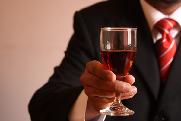 man-holding-glass-of-red-wine-alcohol